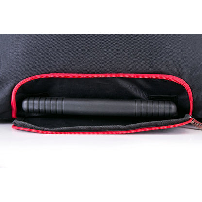 Black cylindrical object inside a black bag with red interior lining on a white background